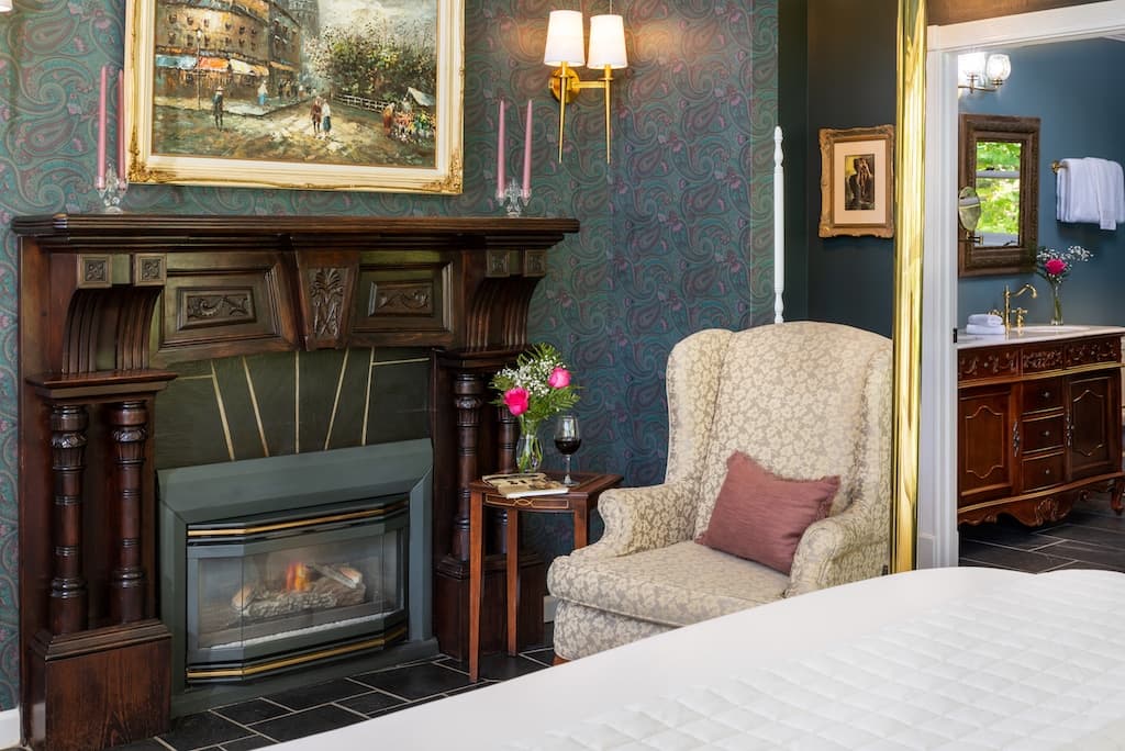 Cozy room with a fireplace, armchair, and ornate decor.