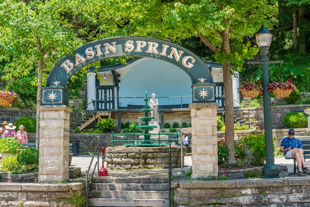Entrance to Basin Spring Park featuring a fountain and lush greenery.