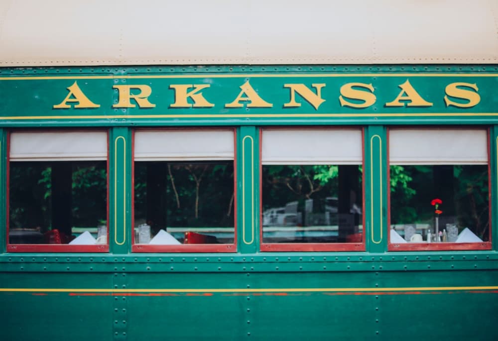 Vintage green train car with "ARKANSAS" in bold yellow letters. Vintage green train car with "ARKANSAS" in bold yellow letters.