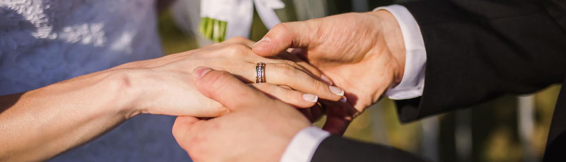 Bride and groom exchanging wedding rings