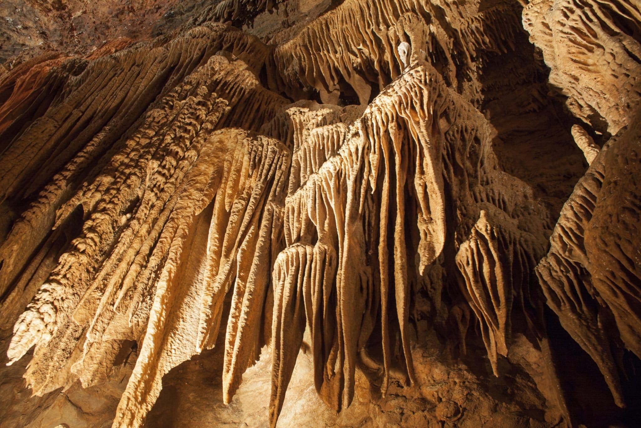 Stalactites and stalagmites create a stunning display of natural rock formations inside a cave.