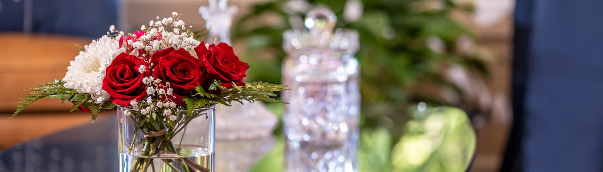 A cozy inn with a vibrant floral arrangement and sparkling glassware