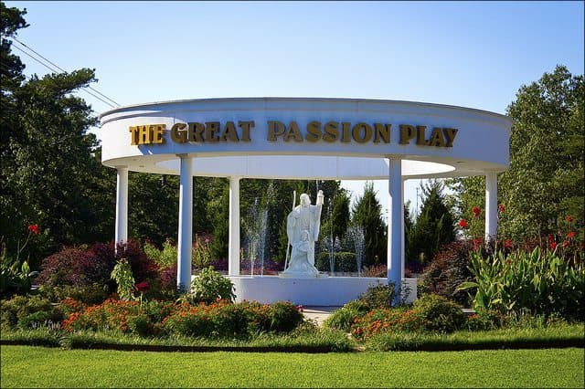 Signage for The Great Passion Play featuring a statue and lush landscaping. Signage for The Great Passion Play featuring a statue and lush landscaping.